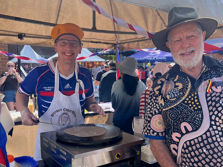 Two men at a food stall.