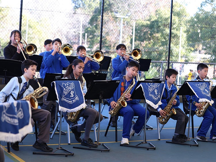 Multiple student playing brass instruments.