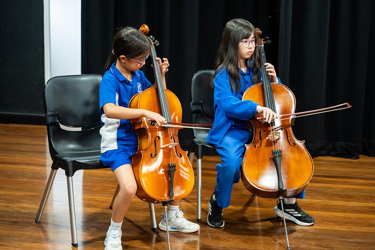 Two girls playing bass.